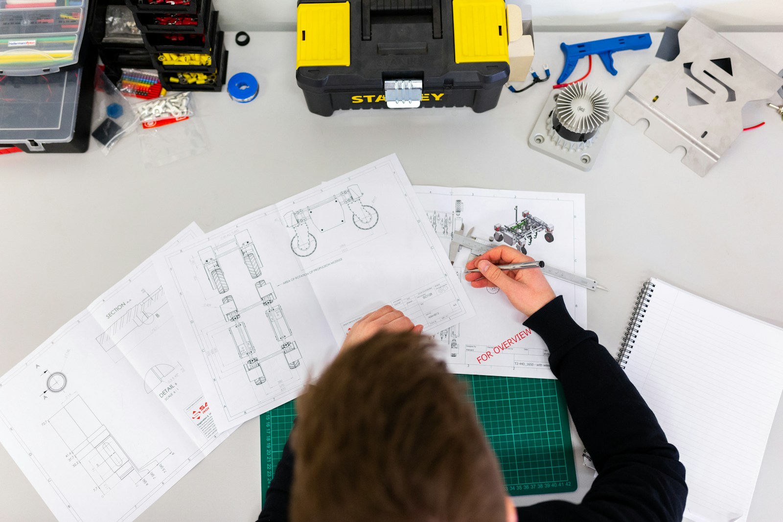 Technician reviewing equipment with QA/QC and site safety compliance